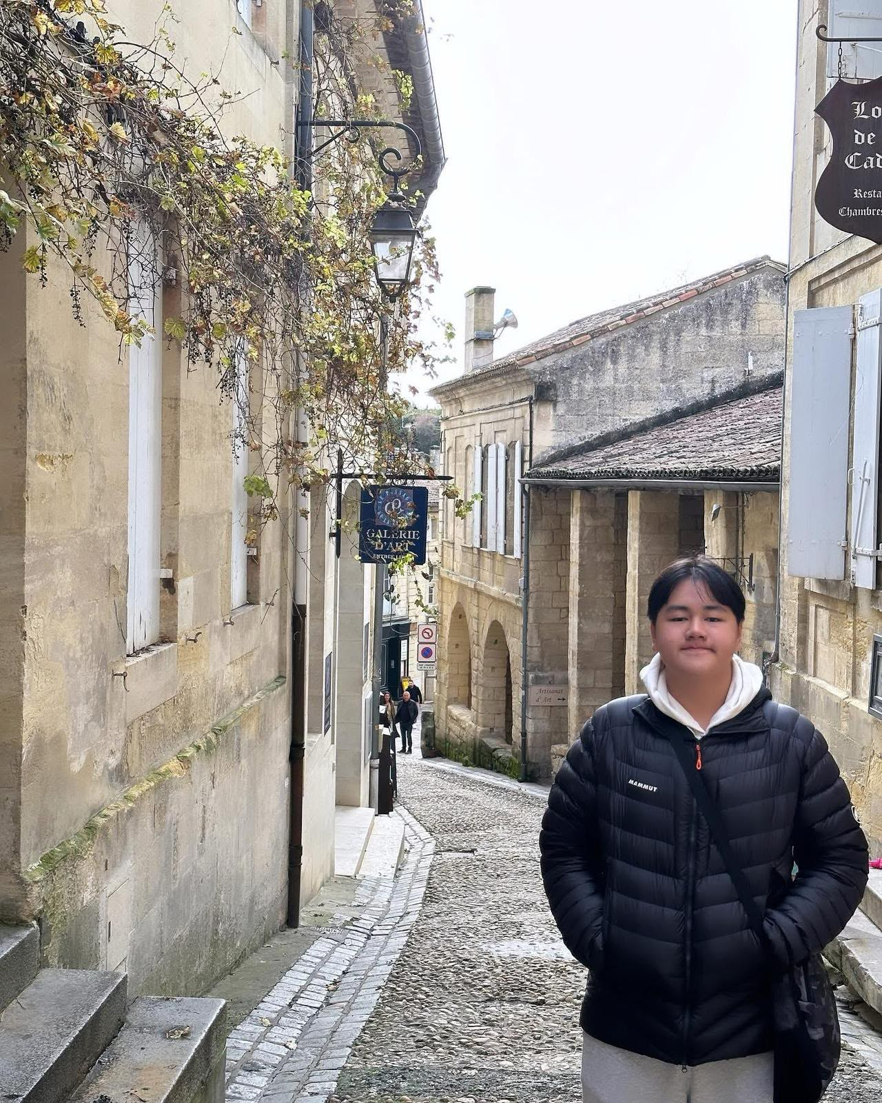 Ignatius Marcus Lee in a dark jacket on a stone-lined street